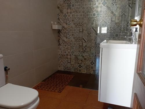 a bathroom with a shower with a toilet and a sink at Casa Lia and friends in Playa Blanca