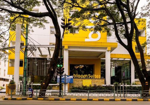 a yellow building with a brown survey sign on it at BloomSuites I Electronics City in Bengaluru