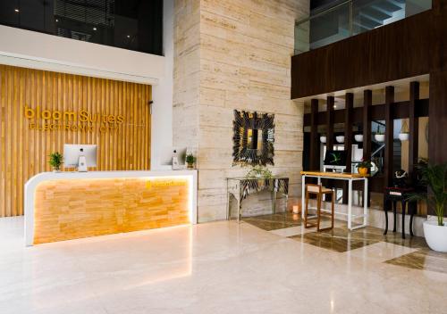 a lobby with a reception desk in a building at BloomSuites I Electronics City in Bangalore