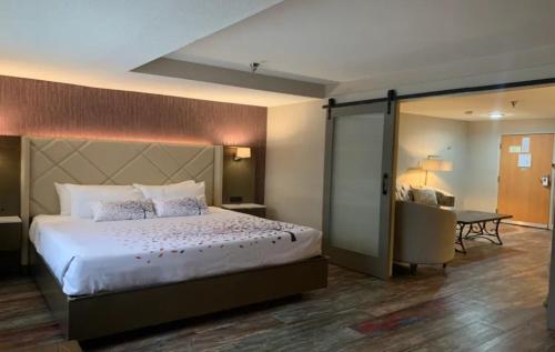 a hotel room with a bed and a desk and a table at Empeiria High Sierra Hotel in Mammoth Lakes