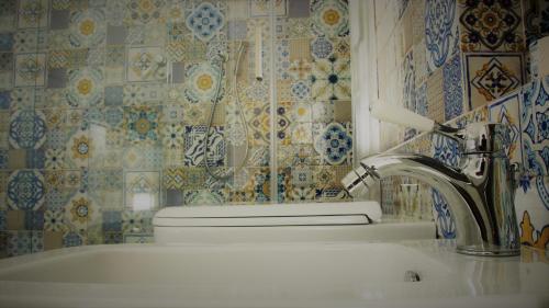 baño con lavabo, grifo y aseo en La Piazza Luxury Hotel & Spa, en Panarea
