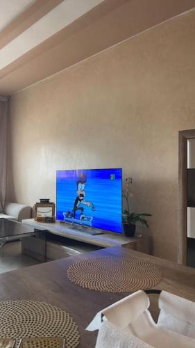 a living room with a flat screen tv on a wall at Lux furnished flat Enjoy ur stay in Nouaceur