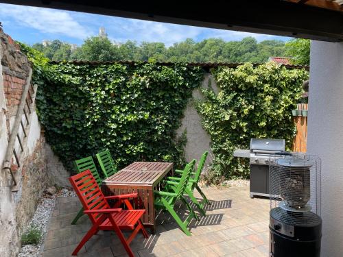 a patio with chairs and a table and a grill at Apartmán U Kapličky in Hluboká nad Vltavou