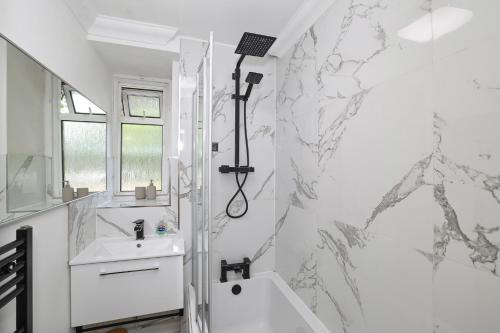a bathroom with a shower and a sink at Bright & modern Islington 2BD apt for 6 in London
