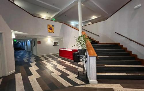 a hallway with stairs and a red table in a building at Empeiria High Sierra Hotel in Mammoth Lakes