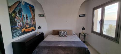 een slaapkamer met een bed en een groot raam bij The View Beach Penthouse in Limassol