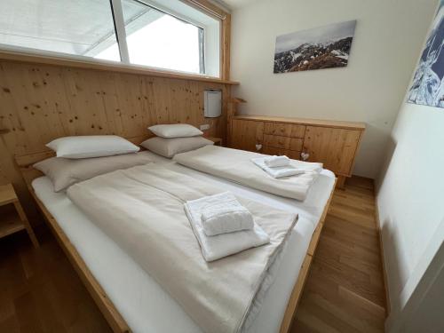 a bedroom with two beds and a window at Apartment Fastenberg Schladming - Top11 by AA Holiday Homes in Schladming