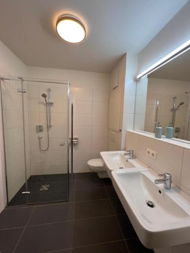 a bathroom with two sinks and a shower at Apartment Fastenberg Schladming - Top11 by AA Holiday Homes in Schladming