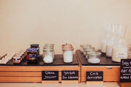 Un mostrador con tarros de comida y botellas de leche. en AMA Ibiza, en Playa d'en Bossa