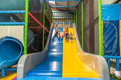 a group of kids playing on a slide at a playground at Camping Country Park Touquin - Site Officiel - Next to Disneyland Paris in Touquin