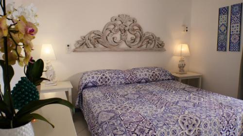 a bedroom with a bed and two tables with lamps at La Piazza Luxury Hotel & Spa in Panarea