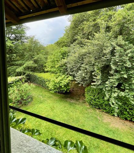 a view of a garden from a window at Locanda Maison Verte in Cantalupa