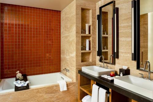 a bathroom with two sinks and a tub at Casa Maat at JW Marriott Los Cabos Beach Resort & Spa in San José del Cabo