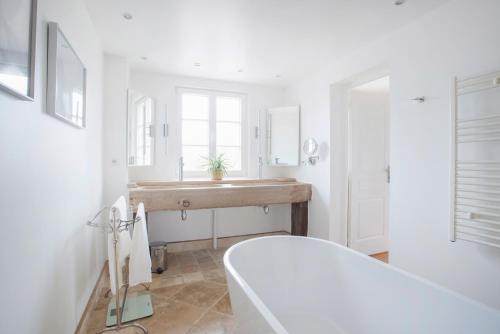 a bathroom with a sink and a bath tub at Villa Emma in Mavilly-Mandelot