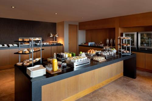 a buffet line with pastries on display in a restaurant at Casa Maat at JW Marriott Los Cabos Beach Resort & Spa in San José del Cabo