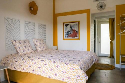 a bedroom with a large bed in a room at Hôtel La Pinède in Saint-Marcellin-lès-Vaison
