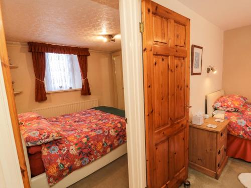 Ένα ή περισσότερα κρεβάτια σε δωμάτιο στο Middle Cottage