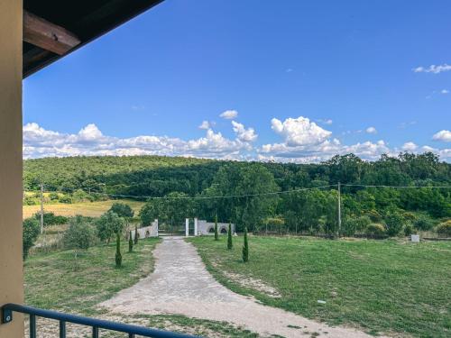 a view of a path in a field with trees at Villa Tuscia apartments in Tuscania