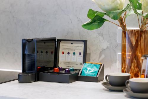 two microwaves sitting on top of a table with cups at Veriu Collingwood in Melbourne