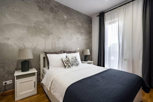 a bedroom with a large bed and a window at Vivando - Bright 1BR - Amazing Terrace + Parking in Bucharest