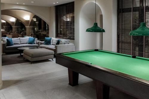 a living room with a pool table in it at Esperos Village Blue & Spa - Adults Only in Faliraki