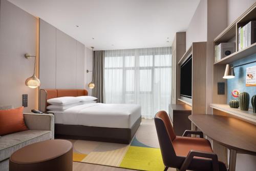 Ένα ή περισσότερα κρεβάτια σε δωμάτιο στο Home2 Suites By Hilton Foshan Jiujiang
