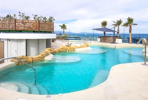 a swimming pool with blue water in a resort at Ocean Spa Plaza Studio Apartment in Gibraltar