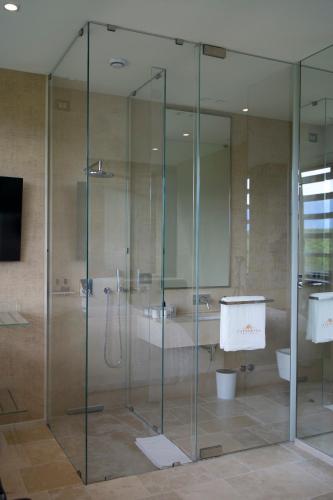 a glass shower in a bathroom with a tub at Foresteria Castorani in Alanno