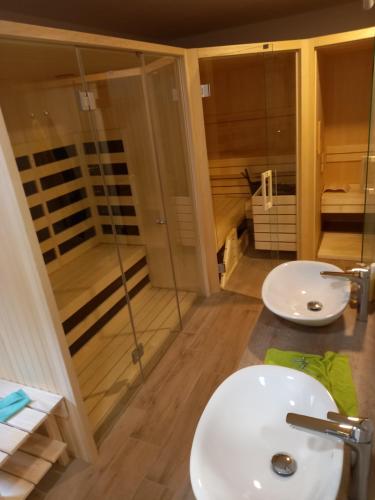 a bathroom with a white sink and a shower at Tubej B&B family room with terrase in Bohinj