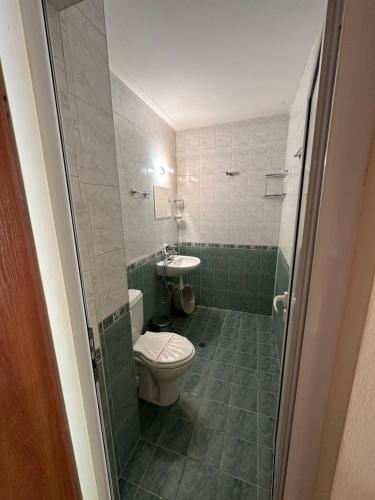 a bathroom with a toilet and a sink at Zora Camping - Bungalows in Obzor