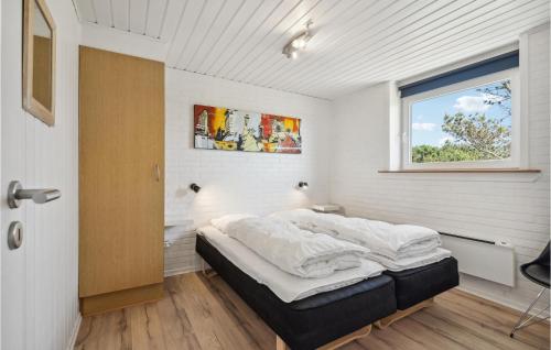 a bedroom with a bed in a room with a window at Amazing Home In Ringkøbing With Sauna in Ringkøbing