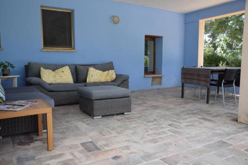 a living room with a couch and a table at Casale di Maro in Monte Giberto