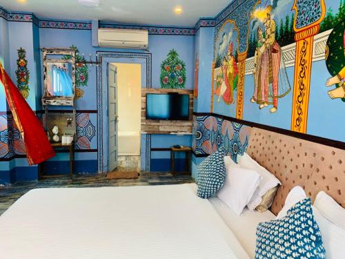 a bedroom with a large bed and blue walls at Rani Mahal in Jodhpur