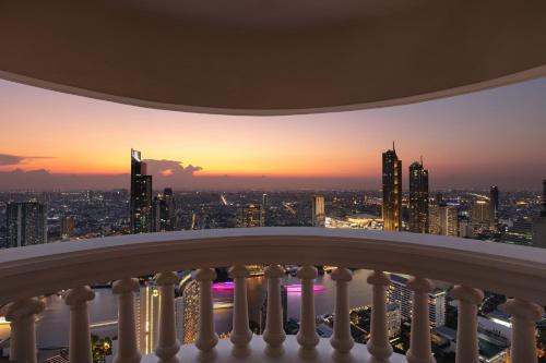 a view from a balcony of a city skyline at sunset at lebua at State Tower in Bangkok