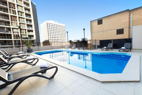 a swimming pool on the roof of a building at Metro Hotel Marlow Sydney Central in Sydney