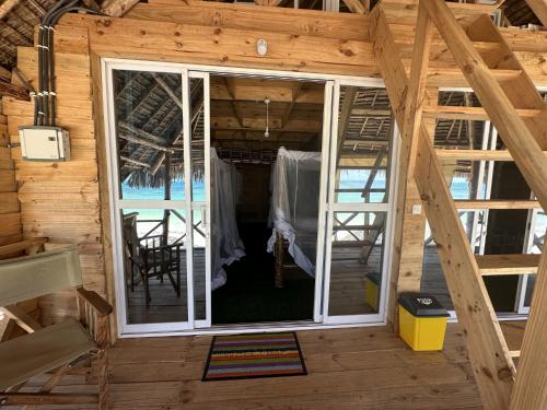 a view of the inside of a wooden cabin with a window at Coconuts Bandas in Jambiani