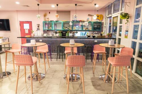 a restaurant with tables and chairs in front of a counter at Abraham Eilat in Eilat