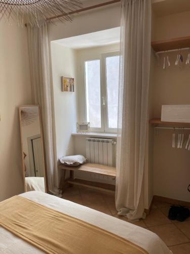 a bedroom with a bed and a window with a bench at Casa Bucciarelle in Casoli