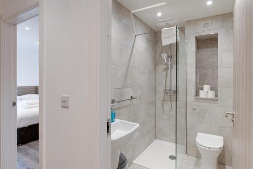 a bathroom with a shower and a toilet and a sink at Liverpool Short Stay Apartments in Liverpool