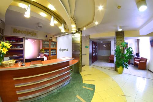a lobby of a hotel with a reception counter at Hotel Panorama Nowy Sącz in Nowy Sącz