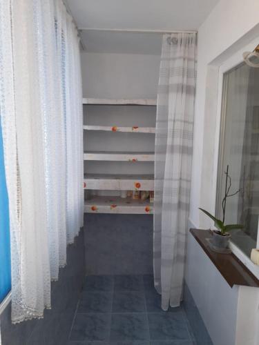 a staircase with white curtains in a bathroom at La Sandu Ocna in Ocna Sibiului