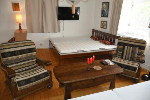 a living room with a bed and chairs and a table at Liškov in Liškov