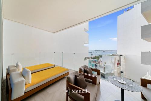 a bedroom with a bed and a table and chairs at Manzil - Lavish 2BR Sea View Apartment in Five Palm, Palm Jumeirah in Dubai