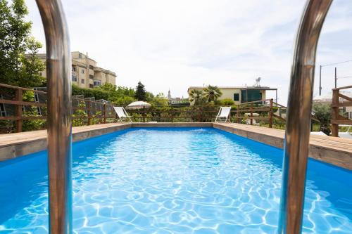 a swimming pool in the middle of a house at Residence O'Sole Mio Pompei in Pompei