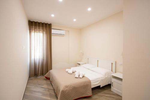 a bedroom with a bed with white pillows on it at Residence O'Sole Mio Pompei in Pompei