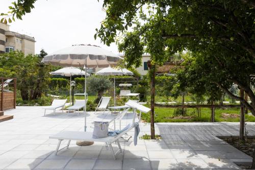 a group of chairs and umbrellas on a patio at Residence O'Sole Mio Pompei in Pompei