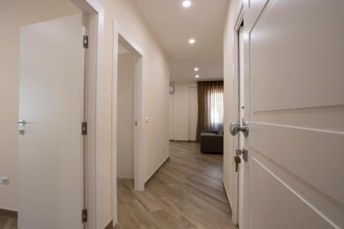 an empty hallway with a door and a living room at Residence O'Sole Mio Pompei in Pompei