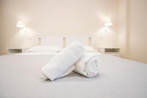 a pile of towels sitting on top of a bed at Residence O'Sole Mio Pompei in Pompei