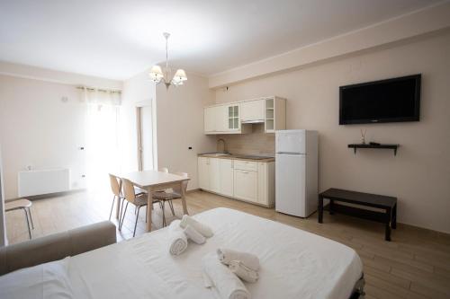 a living room with a bed and a kitchen at Residence O'Sole Mio Pompei in Pompei