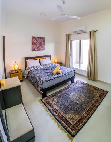 a bedroom with a bed and a large window at Royal Home Luxor Pool View in Luxor